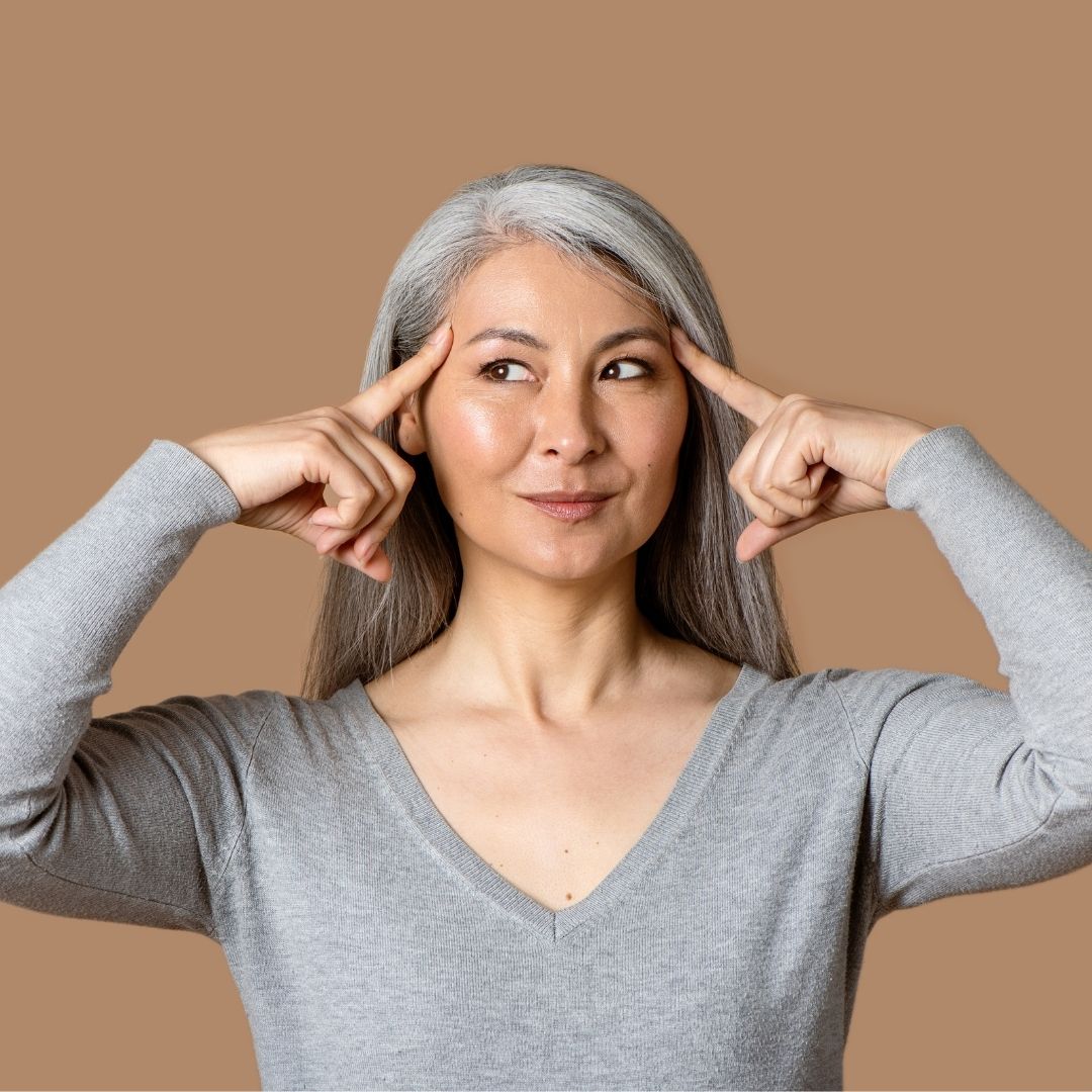 Creative professional woman holding the 5 1oz high function nootropic drinks with both hands in a row, wondering which to choose